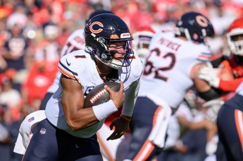 Chicago Bears quarterback Justin Fields (1) carries the ball against the Kansas City Chiefs during the first half of an NFL football game, Sunday, Sept. 24, 2023 in Kansas City, Mo. (AP Photo/Reed Hoffmann)