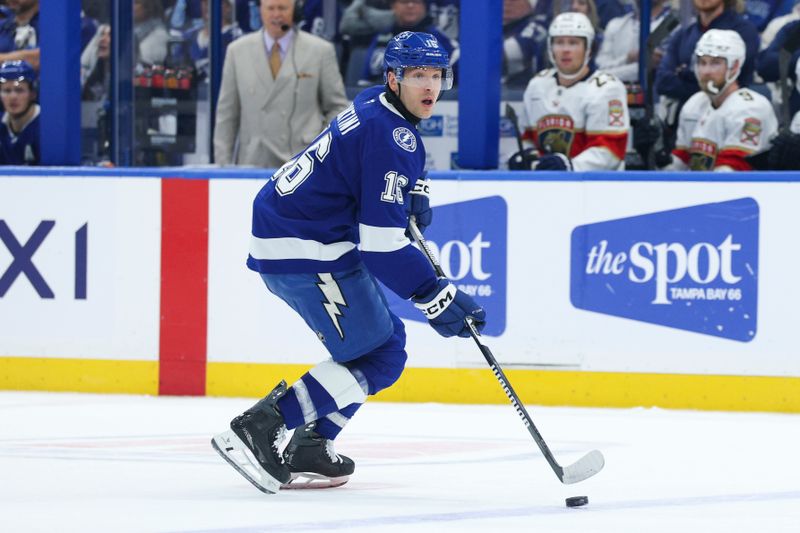 Dec 15, 2025; Tampa, Florida, USA; Tampa Bay Lightning defenseman Steven Santini (16) controls the puck against the Florida Panthers in the first period at Benchmark International Arena. Mandatory Credit: Nathan Ray Seebeck-Imagn Images