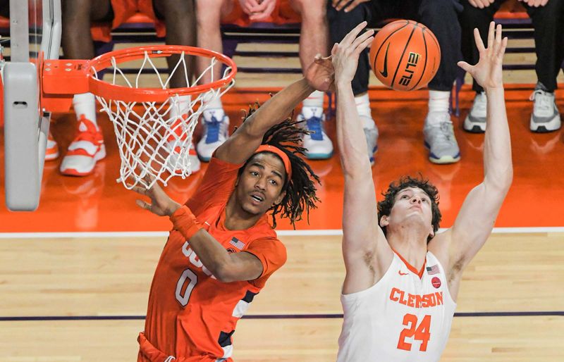 Feb 22, 2023; Clemson, South Carolina, USA; Clemson forward PJ Hall (24) rebounds against Syracuse forward Chris Bell (0) during the first half at Littlejohn Coliseum. Mandatory Credit: Ken Ruinard-USA TODAY Sports