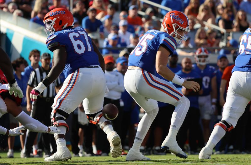 Oct 28, 2023; Jacksonville, Florida, USA; Georgia Bulldogs defensive lineman Tyrion Ingram-Dawkins (not pictured) forces a fumble by Florida Gators quarterback Graham Mertz (15) during the first half at EverBank Stadium. Mandatory Credit: Kim Klement Neitzel-USA TODAY Sports