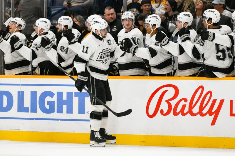 Nov 4, 2024; Nashville, Tennessee, USA;  Los Angeles Kings center Anze Kopitar (11) celebrates his goal with his teammates against the Nashville Predators during the first period at Bridgestone Arena. Mandatory Credit: Steve Roberts-Imagn Images