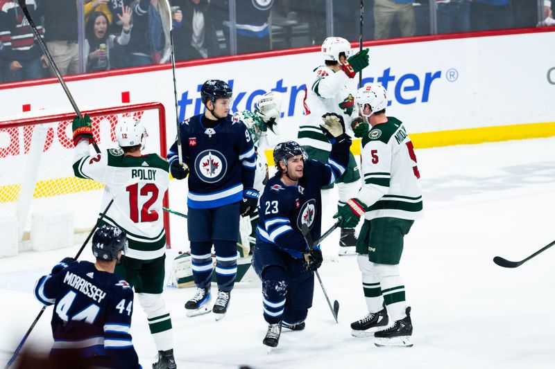 Feb 20, 2024; Winnipeg, Manitoba, CAN; Winnipeg Jets forward Sean Monahan (23) celebrates his goal against the Minnesota Wild during third period at Canada Life Centre. Mandatory Credit: Terrence Lee-USA TODAY Sports