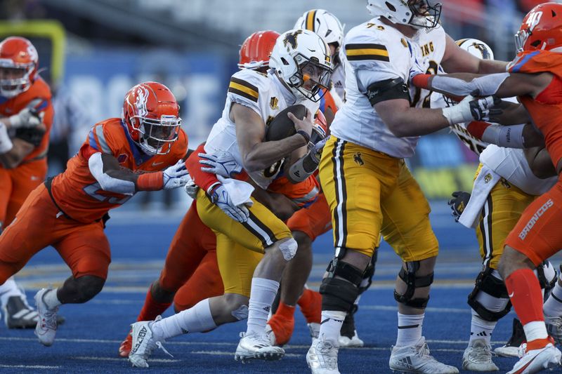 Oct 28, 2023; Boise, Idaho, USA; Wyoming Cowboys quarterback Andrew Peasley (6) is tackled during the second half against the Boise State Broncos at Albertsons Stadium. Mandatory Credit: Brian Losness-USA TODAY Sports