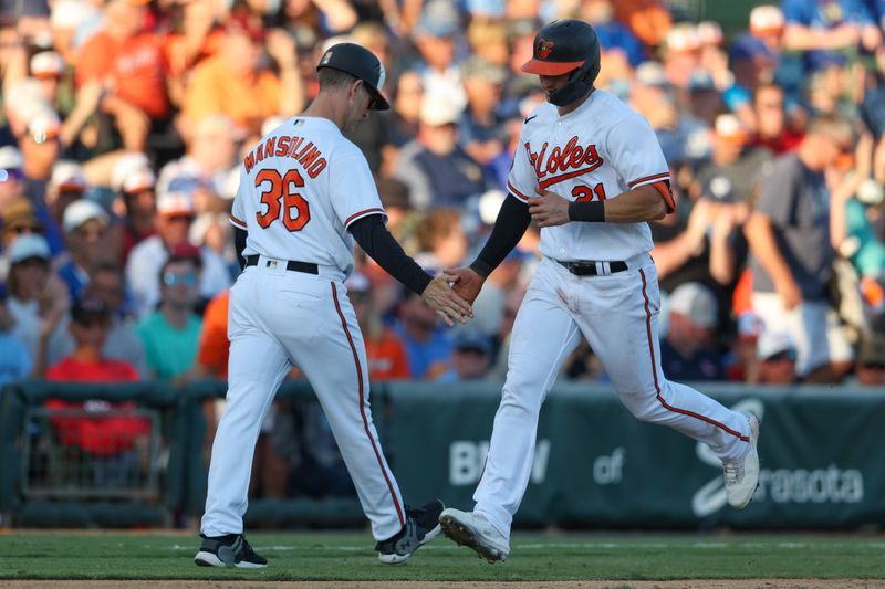 Mar 16, 2023; Sarasota, Florida, USA;  Baltimore Orioles left fielder Austin Hays (21) is congratulated by Baltimore Orioles third base coach Tony Mansolino (36) after hitting a two-run home run against the Toronto Blue Jays in the third inning in the during spring training at Ed Smith Stadium. Mandatory Credit: Nathan Ray Seebeck-USA TODAY Sports