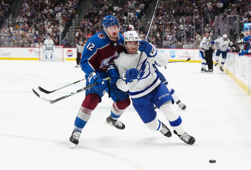 Nov 27, 2023; Denver, Colorado, USA; Colorado Avalanche center Ryan Johansen (12) hits Tampa Bay Lightning left wing Tanner Jeannot (84) in the first period at Ball Arena. Mandatory Credit: Ron Chenoy-USA TODAY Sports