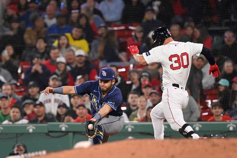 May 16, 2024; Boston, Massachusetts, USA;  Tampa Bay Rays first baseman Jonathan Aranda (62) makes a catch  against Boston Red Sox left fielder Rob Refsnyder (30) during the seventh inning at Fenway Park. Mandatory Credit: Eric Canha-USA TODAY Sports