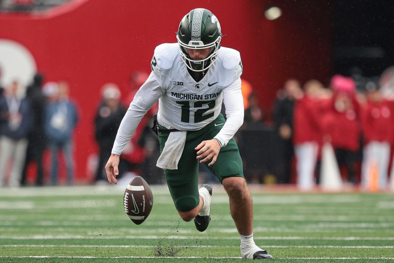 Oct 14, 2023; Piscataway, New Jersey, USA; Michigan State Spartans quarterback Katin Houser (12) recovers his own fumble for a first down during the first half against the Rutgers Scarlet Knights at SHI Stadium. Mandatory Credit: Vincent Carchietta-USA TODAY Sports