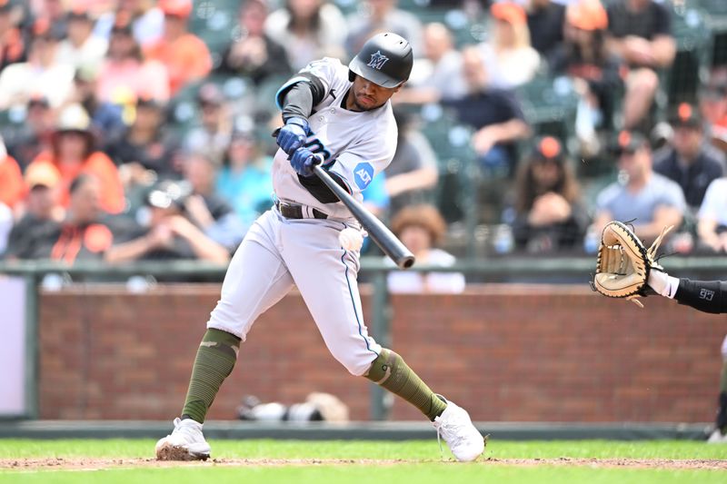 May 21, 2023; San Francisco, California, USA; Miami Marlins infielder Xavier Edwards (63) hits a single against the San Francisco Giants during the seventh inning at Oracle Park. Mandatory Credit: Robert Edwards-USA TODAY Sports