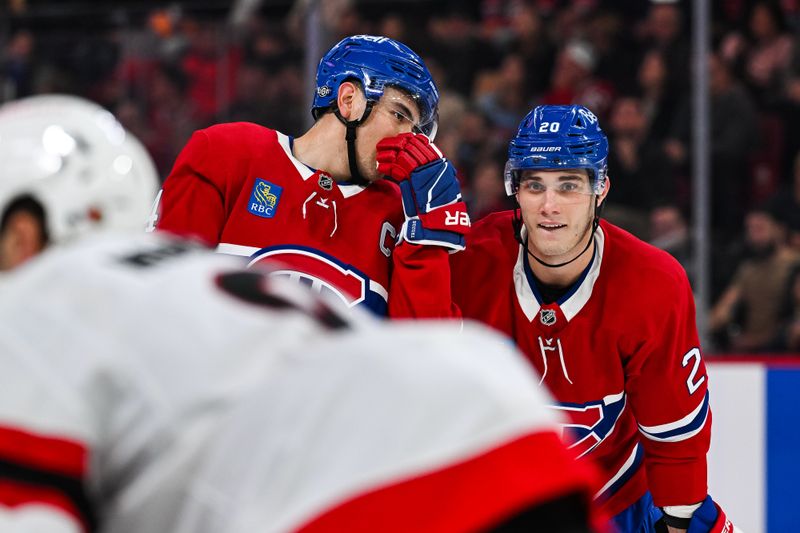 Oct 12, 2024; Montreal, Quebec, CAN; Montreal Canadiens center Nick Suzuki (14) discusses with left wing Juraj Slafkovsky (20) prior to a face-off against the Ottawa Senators during the first period at Bell Centre. Mandatory Credit: David Kirouac-Imagn Images