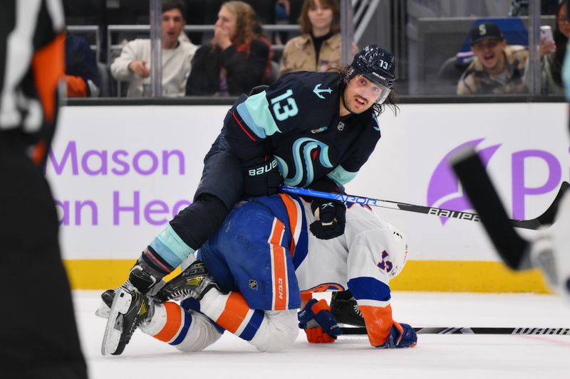 Nov 16, 2023; Seattle, Washington, USA; Seattle Kraken left wing Brandon Tanev (13) pushes New York Islanders center Mathew Barzal (13) down during the third period at Climate Pledge Arena. Mandatory Credit: Steven Bisig-USA TODAY Sports