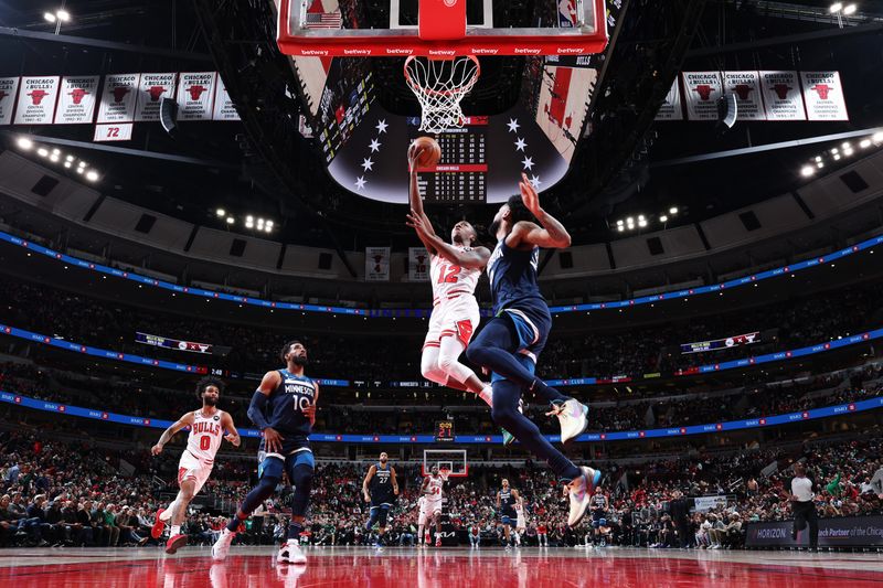 CHICAGO, IL - MARCH 17: Ayo Dosunmu #12 of the Chicago Bulls drives to the basket during the game against the Minnesota Timberwolves on March 17, 2023 at United Center in Chicago, Illinois. NOTE TO USER: User expressly acknowledges and agrees that, by downloading and or using this photograph, User is consenting to the terms and conditions of the Getty Images License Agreement. Mandatory Copyright Notice: Copyright 2023 NBAE (Photo by Jeff Haynes/NBAE via Getty Images)