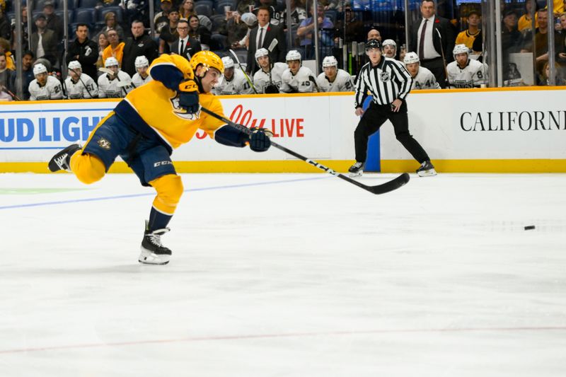 Nov 4, 2024; Nashville, Tennessee, USA;  Nashville Predators center Tommy Novak (82) takes a shot on goal against the Los Angeles Kings during the first period at Bridgestone Arena. Mandatory Credit: Steve Roberts-Imagn Images