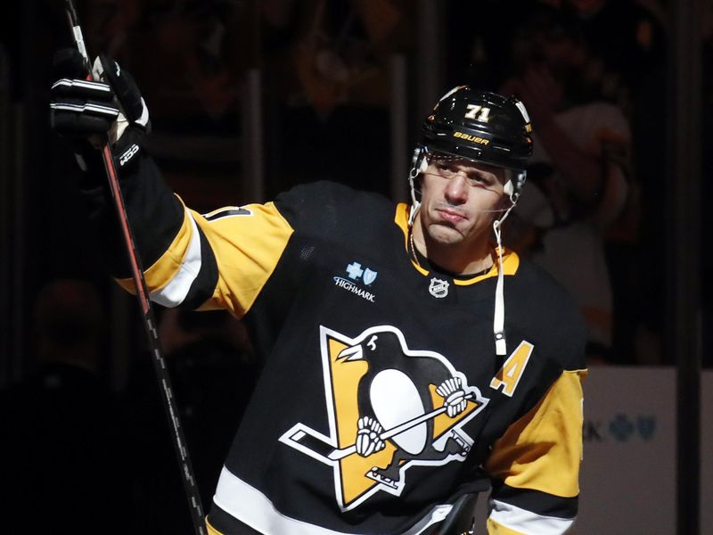 Oct 16, 2024; Pittsburgh, Pennsylvania, USA; Pittsburgh Penguins center Evgeni Malkin (71) reacts after being named first star of the game against the Buffalo Sabres in overtime at PPG Paints Arena. Malkin recorded NHL career goal number 500 in the contest. Mandatory Credit: Charles LeClaire-Imagn Images