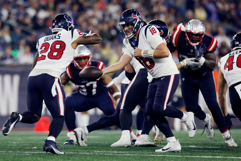 Houston Texans quarterback Case Keenum (18) hands off to running back Gerrid Doaks during the second half of the team's NFL preseason football game against the New England Patriots, Thursday, Aug. 10, 2023, in Foxborough, Mass. (AP Photo/Michael Dwyer)