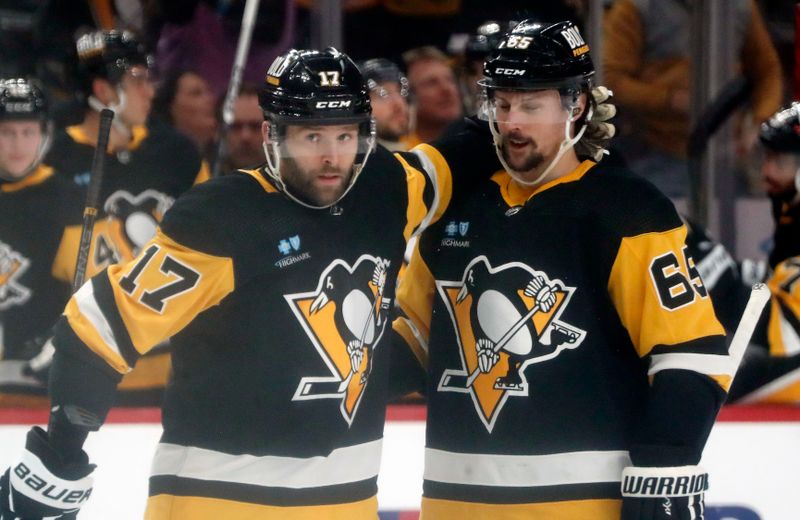 Mar 26, 2024; Pittsburgh, Pennsylvania, USA; Pittsburgh Penguins right wing Bryan Rust (17) celebrates his goal with Penguins defenseman Erik Karlsson (65) against the Carolina Hurricanes during the second period at PPG Paints Arena. Mandatory Credit: Charles LeClaire-USA TODAY Sports