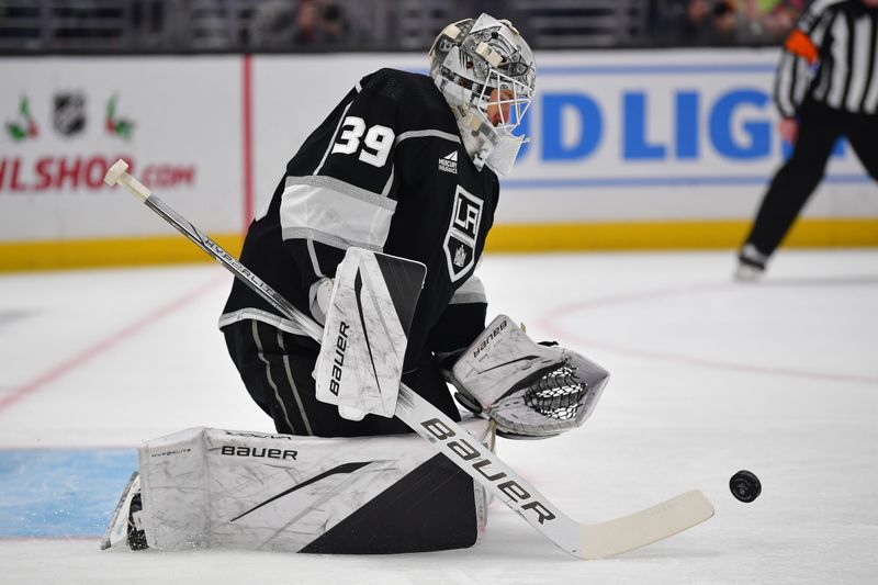 Dec 13, 2023; Los Angeles, California, USA; Los Angeles Kings goaltender Cam Talbot (39) blocks a shot against the Winnipeg Jets during the first period at Crypto.com Arena. Mandatory Credit: Gary A. Vasquez-USA TODAY Sports