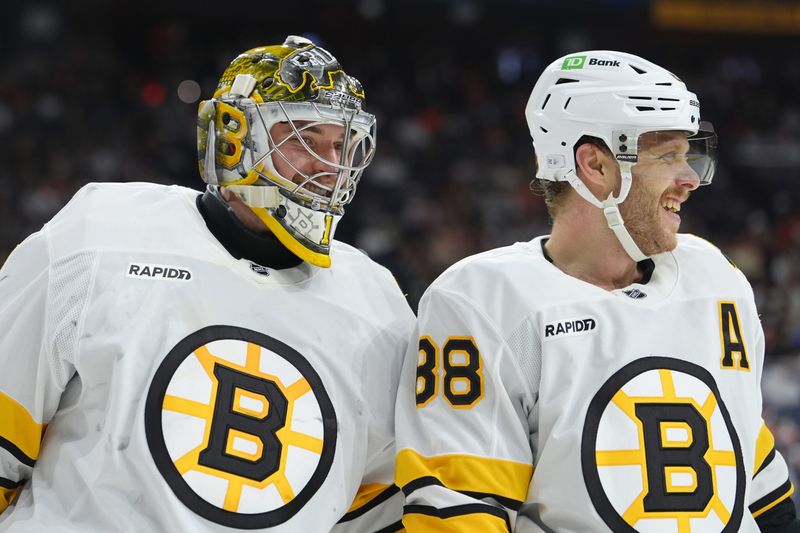 Feb 28, 2026; Philadelphia, Pennsylvania, USA; Boston Bruins goalie Jeremy Swayman (1) reacts with right wing David Pastrnak (88) against the Philadelphia Flyers in the second period at Xfinity Mobile Arena. Mandatory Credit: Kyle Ross-Imagn Images