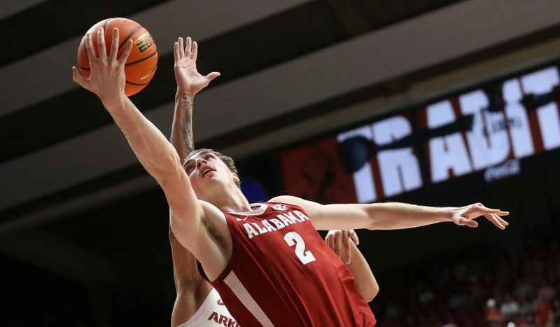 Mar 9, 2024; Tuscaloosa, Alabama, USA;  Alabama forward Grant Nelson (2) goes to the basket against Arkansas at Coleman Coliseum. Alabama came from behind to win on overtime 92-88. Mandatory Credit: Gary Cosby Jr.-USA TODAY Sports