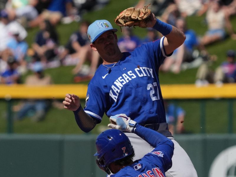 Mar 11, 2026; Mesa, Arizona, USA; Kansas City Royals shortstop Kevin Newman (27) forces out Chicago Cubs shortstop Dansby Swanson (7) in the third inning at Sloan Park. Mandatory Credit: Rick Scuteri-Imagn Images