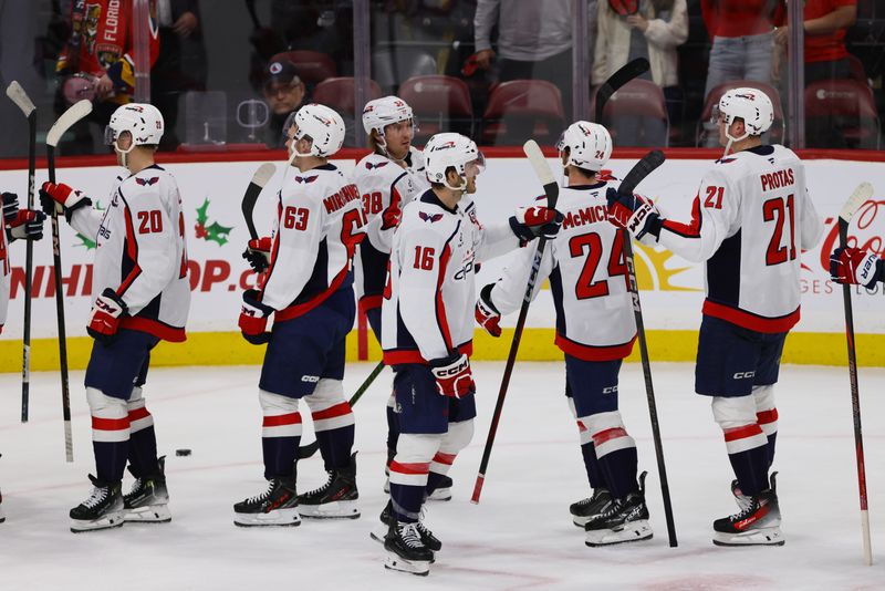 Nov 25, 2024; Sunrise, Florida, USA; Washington Capitals right wing Taylor Raddysh (16) celebrates with teammates after the game against the Florida Panthers at Amerant Bank Arena. Mandatory Credit: Sam Navarro-Imagn Images