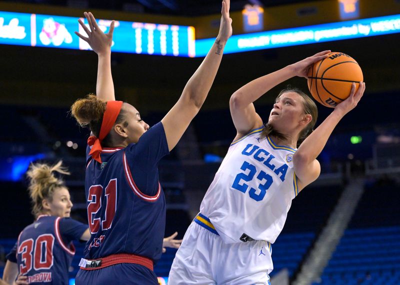 Dec 20, 2022; Los Angeles, California, USA;  UCLA Bruins forward Gabriela Jaquez (23) is defended by Fresno State Bulldogs forward Imani Lacy (21) as she goes for a shot in the first half at Pauley Pavilion presented by Wescom. Mandatory Credit: Jayne Kamin-Oncea-USA TODAY Sports