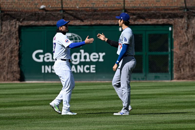 Apr 6, 2024; Chicago, Illinois, USA;  Chicago Cubs outfielder Seiya Suzuki (27) and Los Angeles Dodgers two-way player Shohei Ohtani (17) talk before their teams game at Wrigley Field. Mandatory Credit: Matt Marton-USA TODAY Sports