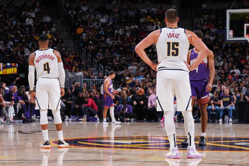 DENVER, CO - OCTOBER 13: Russell Westbrook #4 and Nikola Jokic #15 of the Denver Nuggets look on during the game against the Phoenix Suns on October 13, 2024 at Ball Arena in Denver, Colorado. NOTE TO USER: User expressly acknowledges and agrees that, by downloading and/or using this Photograph, user is consenting to the terms and conditions of the Getty Images License Agreement. Mandatory Copyright Notice: Copyright 2024 NBAE (Photo by Garrett Ellwood/NBAE via Getty Images)
