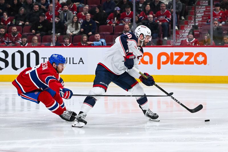 Mar 12, 2024; Montreal, Quebec, CAN; Columbus Blue Jackets center Boone Jenner (38) shoots the puck as Montreal Canadiens defenseman Mike Matheson (8) defends during the second period at Bell Centre. Mandatory Credit: David Kirouac-USA TODAY Sports