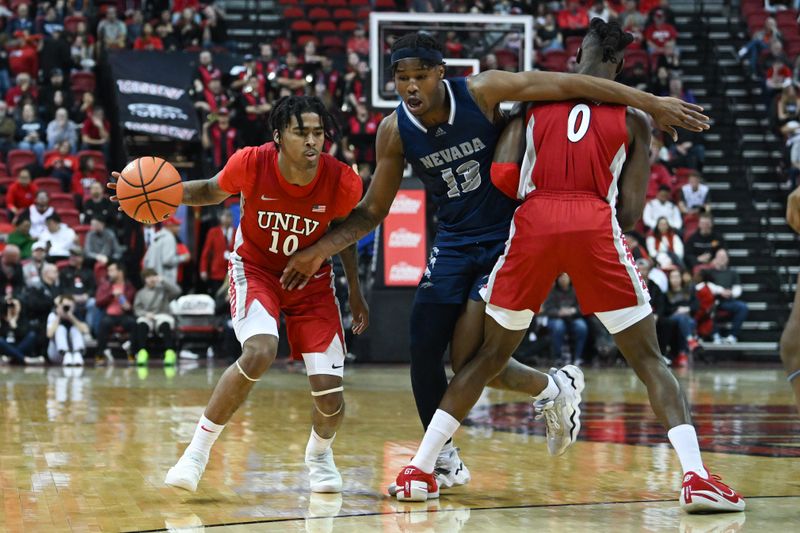 Jan 28, 2023; Las Vegas, Nevada, USA; UNLV Runnin' Rebels guard Keshon Gilbert (10) dribbles around Nevada Wolf Pack guard Kenan Blackshear (13) in the second half at Thomas & Mack Center. Mandatory Credit: Candice Ward-USA TODAY Sports