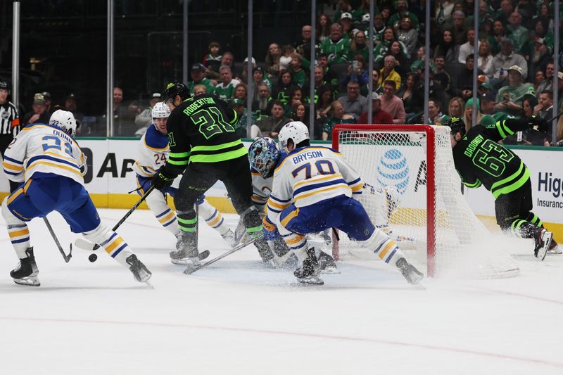 Dec 31, 2024; Dallas, Texas, USA; Dallas Stars left wing Jason Robertson (21) attempts to control the puck against the Buffalo Sabres during the third period at American Airlines Center. Mandatory Credit: Tim Heitman-Imagn Images
