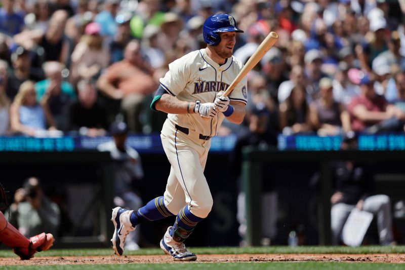 Jun 30, 2024; Seattle, Washington, USA; Seattle Mariners right fielder Luke Raley (20) runs to first on an RBI single against the Minnesota Twins during the fifth inning at T-Mobile Park. Mandatory Credit: John Froschauer-USA TODAY Sports
