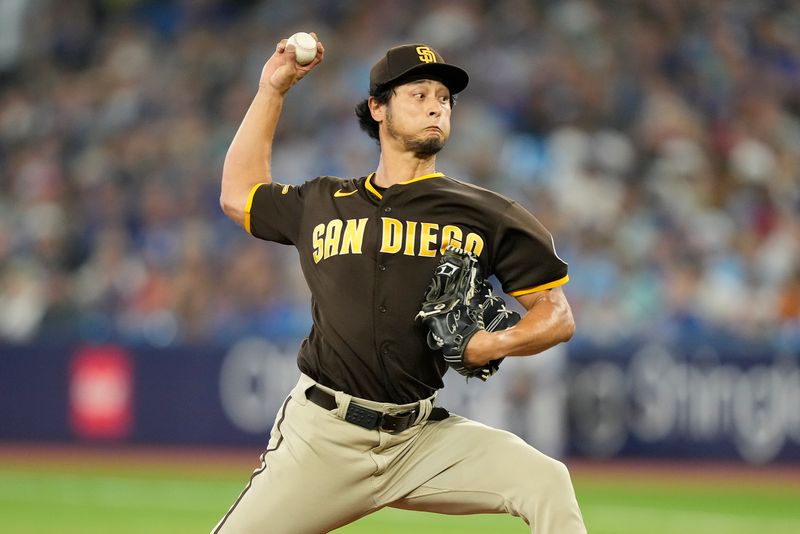 Jul 19, 2023; Toronto, Ontario, CAN; San Diego Padres starting pitcher Yu Darvish (11) pitches to the Toronto Blue Jays during the first inning at Rogers Centre. Mandatory Credit: John E. Sokolowski-USA TODAY Sports