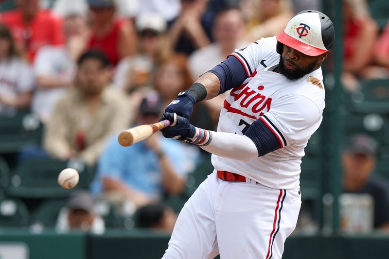 Mar 6, 2024; Fort Myers, Florida, USA;  Minnesota Twins first baseman Carlos Santana (30) singles against the Boston Red Sox in the fourth inning at Hammond Stadium. Mandatory Credit: Nathan Ray Seebeck-USA TODAY Sports