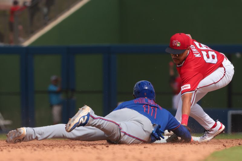 Mar 5, 2026; West Palm Beach, Florida, USA; Washington Nationals shortstop Seaver King (66) tags New York Mets second baseman Jorge Polanco (11) out at second base during the fifth inning at CACTI Park of the Palm Beaches. Mandatory Credit: Sam Navarro-Imagn Images