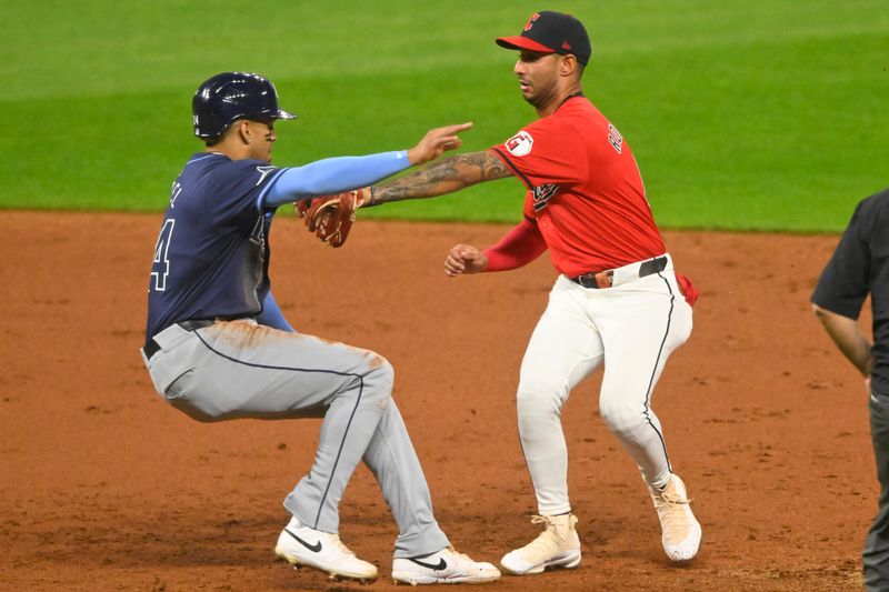 Sep 12, 2024; Cleveland, Ohio, USA; Tampa Bay Rays left fielder Christopher Morel (24) is tagged out by Cleveland Guardians shortstop Brayan Rocchio (4) to compete a double play in the third inning at Progressive Field. Mandatory Credit: David Richard-Imagn Images