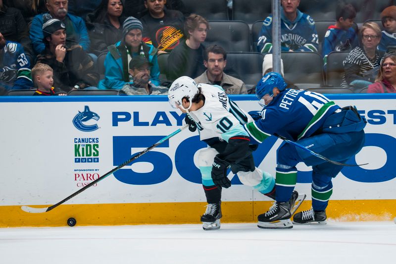 Jan 2, 2026; Vancouver, British Columbia, CAN; Vancouver Canucks forward Elias Pettersson (40) battles with Seattle Kraken forward Matty Beniers (10) in the third period at Rogers Arena. Mandatory Credit: Bob Frid-Imagn Images