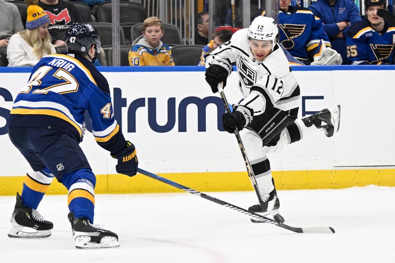 Jan 28, 2024; St. Louis, Missouri, USA; Los Angeles Kings left wing Trevor Moore (12) shot is blocked by St. Louis Blues defenseman Torey Krug (47) during the first period at Enterprise Center. Mandatory Credit: Jeff Le-USA TODAY Sports