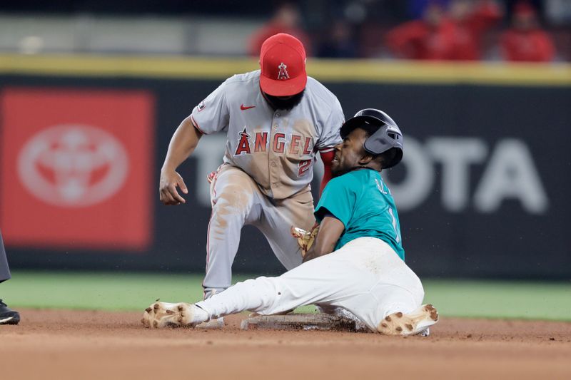 Jun 1, 2024; Seattle, Washington, USA;  Seattle Mariners second baseman Ryan Bliss (1) collides with Los Angeles Angels second baseman Luis Rengifo (2) as he advances on a fly out during the sixth inning at T-Mobile Park. Mandatory Credit: John Froschauer-USA TODAY Sports