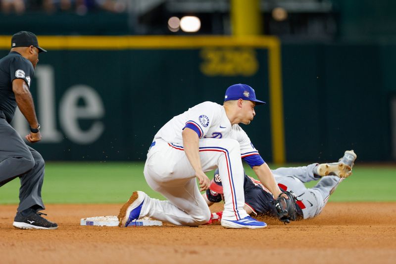 May 1, 2024; Arlington, Texas, USA; Washington Nationals outfielder Jacob Young (30) slides past a tag attempt by Texas Rangers shortstop Corey Seager (5) during the 9th inning at Globe Life Field. Mandatory Credit: Andrew Dieb-USA TODAY Sports