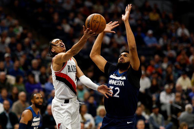 MINNEAPOLIS, MINNESOTA - MARCH 04: Dalano Banton #5 of the Portland Trail Blazers draws a foul against Karl-Anthony Towns #32 of the Minnesota Timberwolves on a shot attempt in the first quarter at Target Center on March 04, 2024 in Minneapolis, Minnesota. NOTE TO USER: User expressly acknowledges and agrees that, by downloading and or using this photograph, User is consenting to the terms and conditions of the Getty Images License Agreement. (Photo by David Berding/Getty Images)