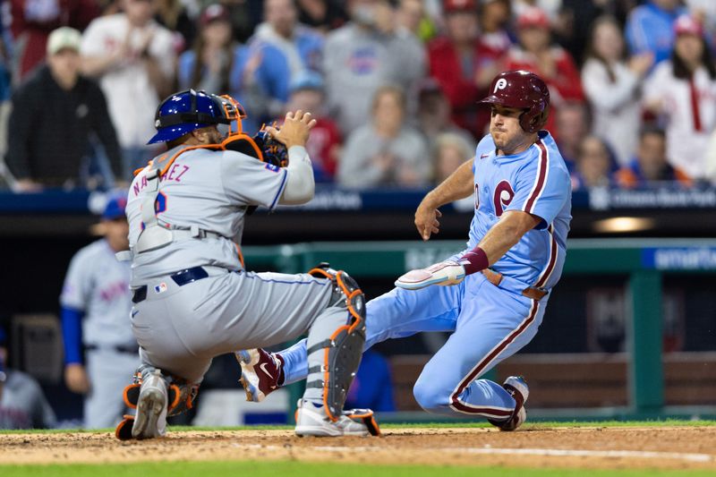 May 16, 2024; Philadelphia, Pennsylvania, USA; Philadelphia Phillies catcher J.T. Realmuto (10) scores past the tag attempt of New York Mets catcher Omar Narváez (2) during the sixth inning at Citizens Bank Park. Mandatory Credit: Bill Streicher-USA TODAY Sports