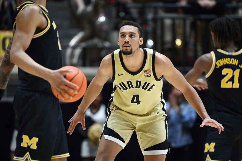 Feb 17, 2026; West Lafayette, Indiana, USA; Purdue Boilermakers forward Trey Kaufman-Renn (4) defends against Michigan Wolverines forward Yaxel Lendeborg (23) during the second half at Mackey Arena. Mandatory Credit: Marc Lebryk-Imagn Images