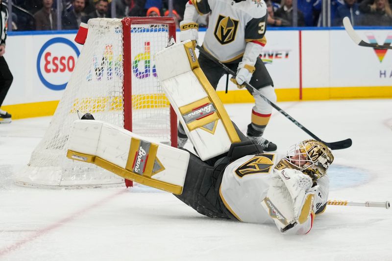 Nov 20, 2024; Toronto, Ontario, CAN; Vegas Golden Knights goaltender Adin Hill (33) defends his goal against the Toronto Maple Leafs during the third period at Scotiabank Arena. Mandatory Credit: John E. Sokolowski-Imagn Images