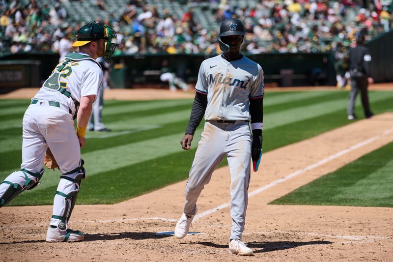 May 5, 2024; Oakland, California, USA; Miami Marlins outfielder Nick Gordon (1) scores a run against the Oakland Athletics during the sixth inning at Oakland-Alameda County Coliseum. Mandatory Credit: Robert Edwards-USA TODAY Sports