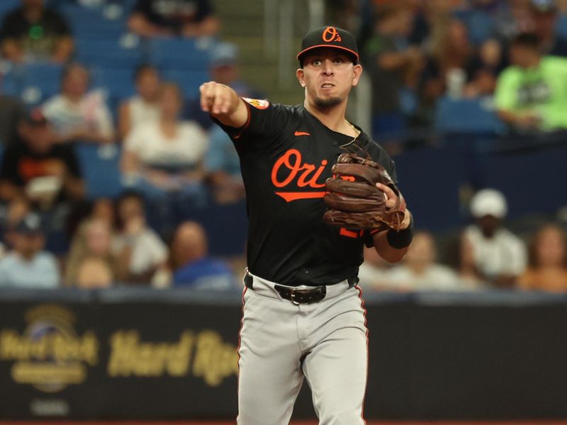 Aug 11, 2024; St. Petersburg, Florida, USA;  Baltimore Orioles third base Ramon Urias (29) throws the ball to first base for an out against the Tampa Bay Rays during the seventh inning at Tropicana Field. Mandatory Credit: Kim Klement Neitzel-USA TODAY Sports