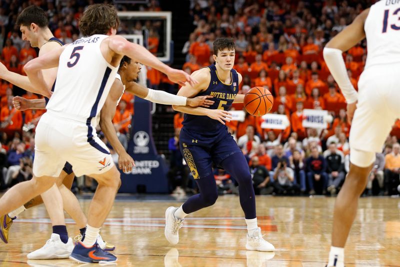 Feb 18, 2023; Charlottesville, Virginia, USA; Notre Dame Fighting Irish guard Cormac Ryan (5) controls the ball as Virginia Cavaliers guard Armaan Franklin (4) and Cavaliers forward Ben Vander Plas (5) defend during the first half at John Paul Jones Arena. Mandatory Credit: Amber Searls-USA TODAY Sports