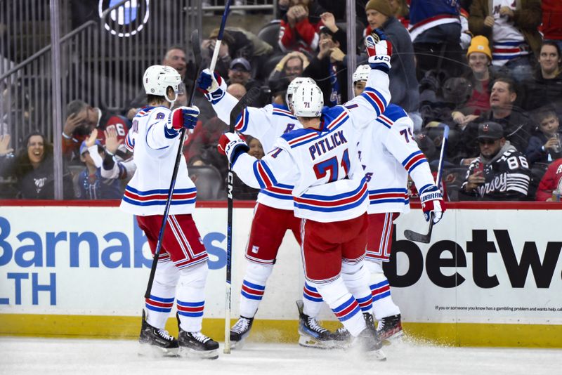 Nov 18, 2023; Newark, New Jersey, USA; New York Rangers left wing Jimmy Vesey (26) celebrates with teammates after scoring a goal against the New Jersey Devils during the third period at Prudential Center. Mandatory Credit: John Jones-USA TODAY Sports