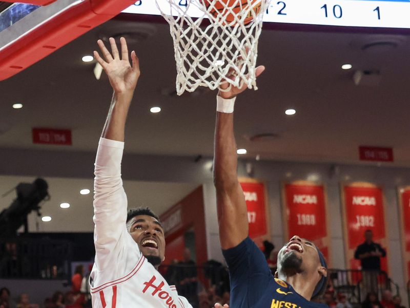 Jan 15, 2025; Houston, Texas, USA; Houston Cougars guard Mylik Wilson (8) shoots against West Virginia Mountaineers guard Sencire Harris (10) in the first half at Fertitta Center. Mandatory Credit: Thomas Shea-Imagn Images