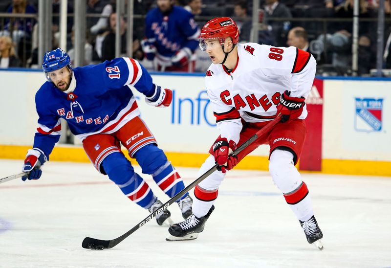 Jan 2, 2024; New York, New York, USA; Carolina Hurricanes center Martin Necas (88) and New York Rangers center Nick Bonino (12) chase the puck during the third period at Madison Square Garden. Mandatory Credit: Danny Wild-USA TODAY Sports