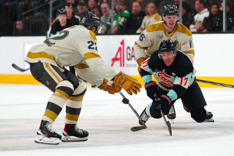 Mar 21, 2024; Las Vegas, Nevada, USA; Seattle Kraken center Jaden Schwartz (17) attempts to dump the puck into the zone between Vegas Golden Knights left wing Pavel Dorofeyev (16) and Vegas Golden Knights right wing Michael Amadio (22) during the third period at T-Mobile Arena. Mandatory Credit: Stephen R. Sylvanie-USA TODAY Sports